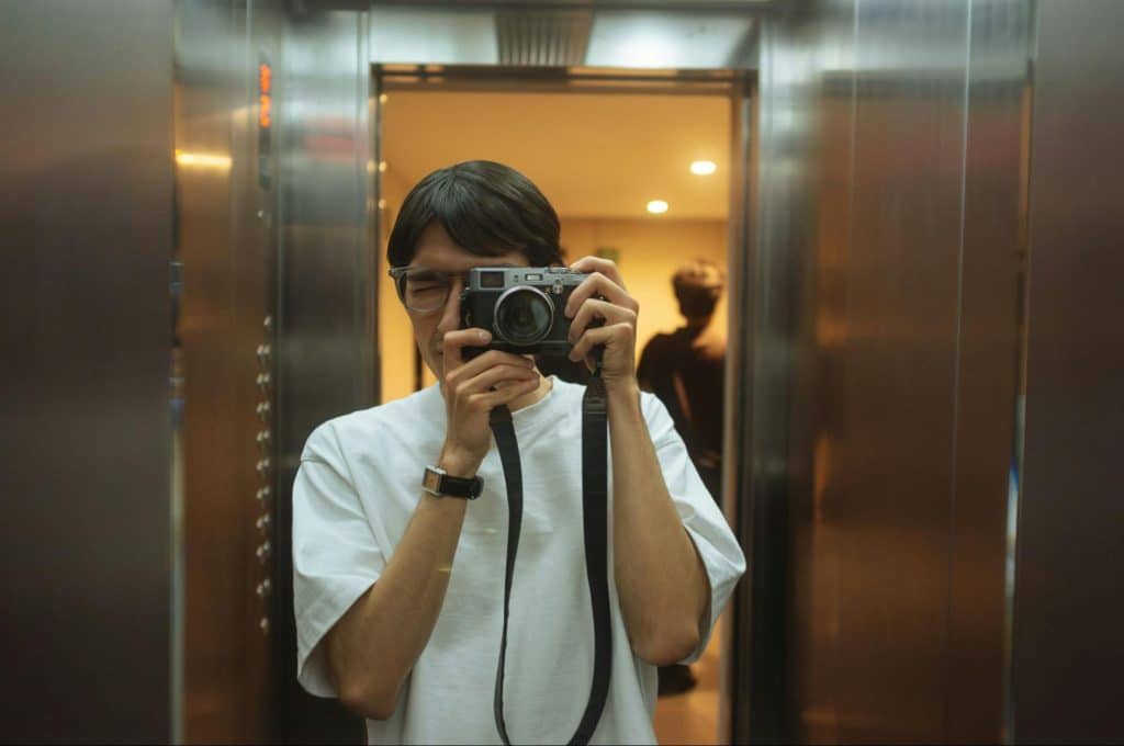 A man taking a picture at the elevator.