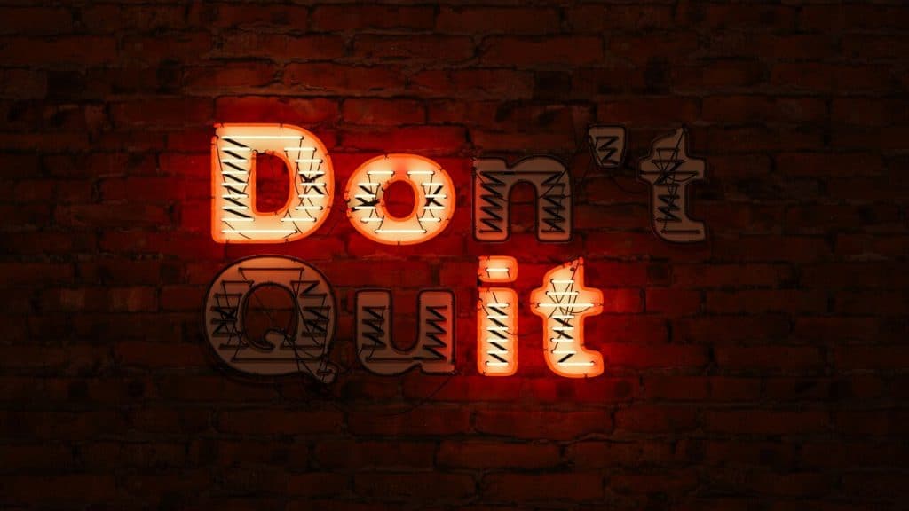 Neon lights spelling out “don’t quit”