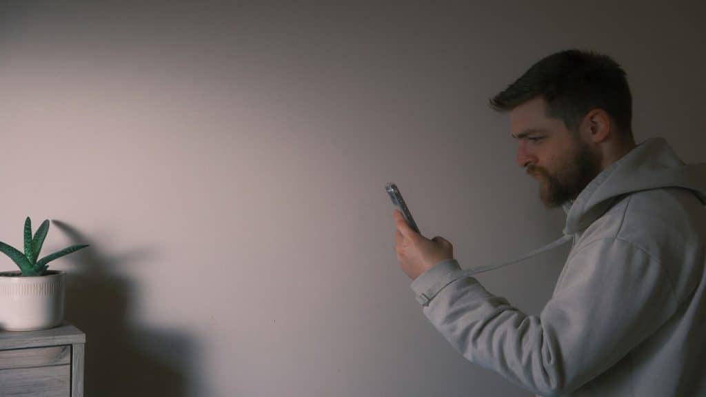 A man using his phone at home