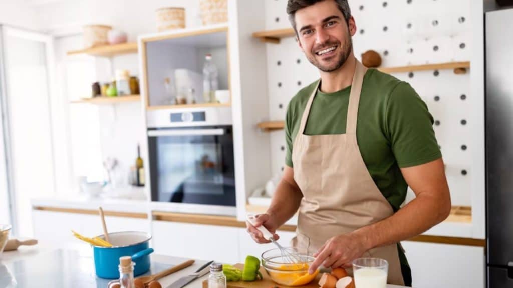 Man cooking a protein rich breakfast at a modern kitchen counter.