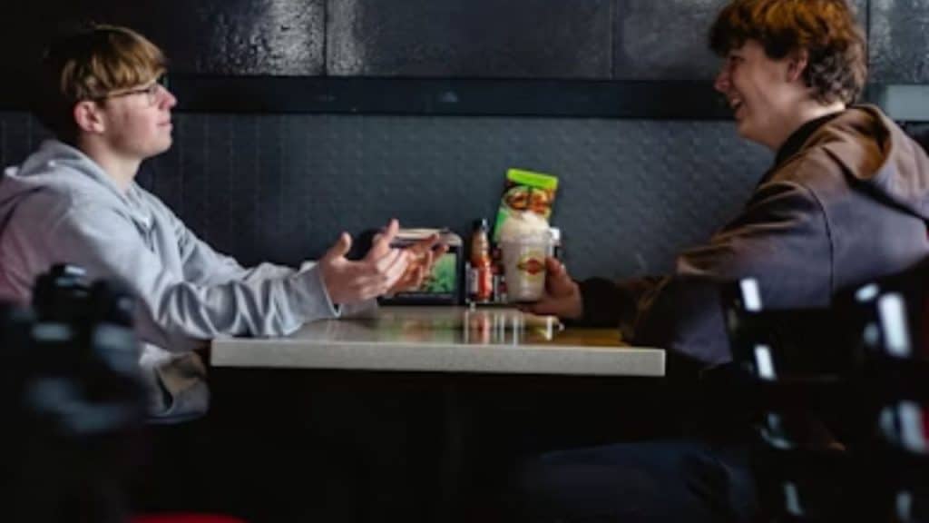 Father and teen enjoying weekly bonding tradition at their favorite diner