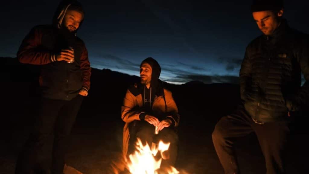 Group of men laughing around a campfire or game night