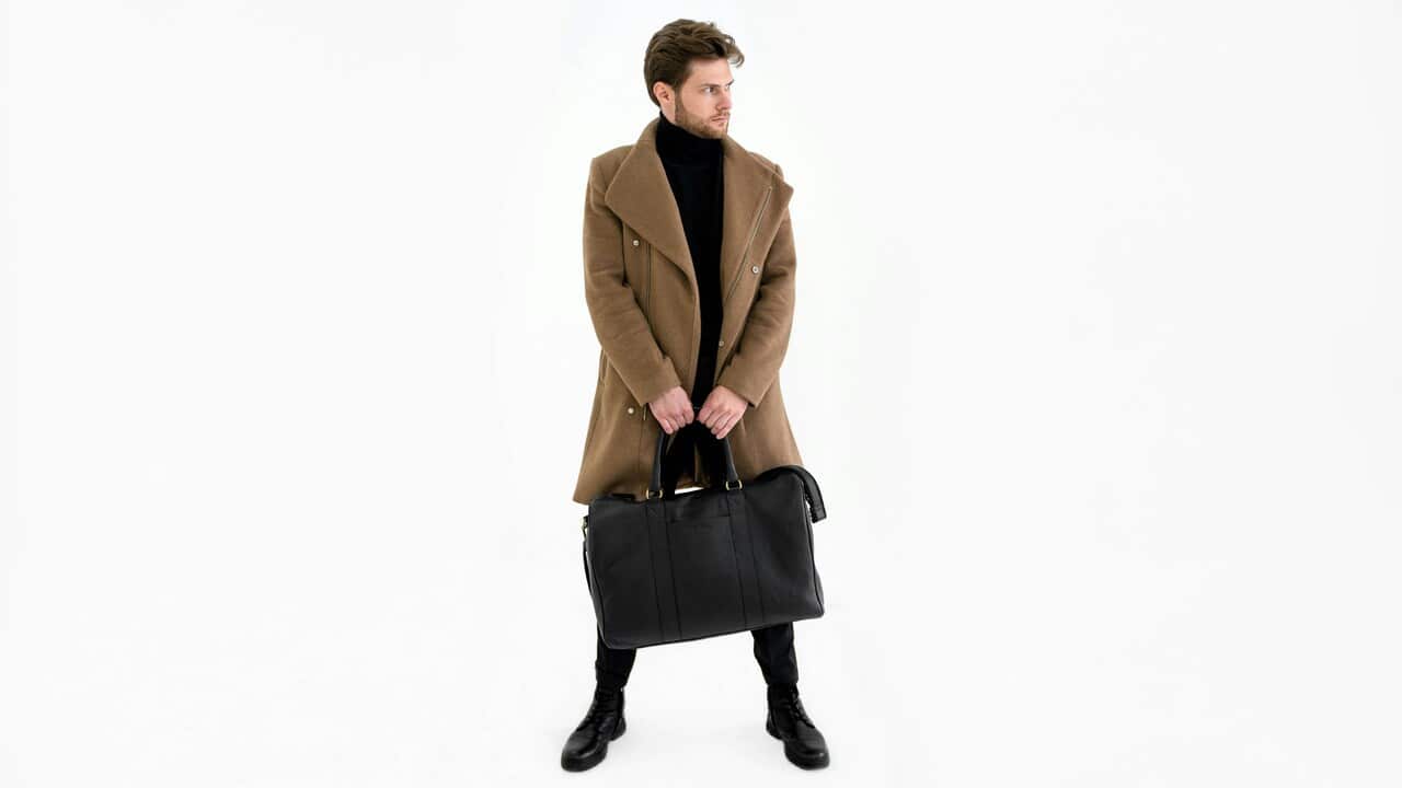 A man carrying a black bag.