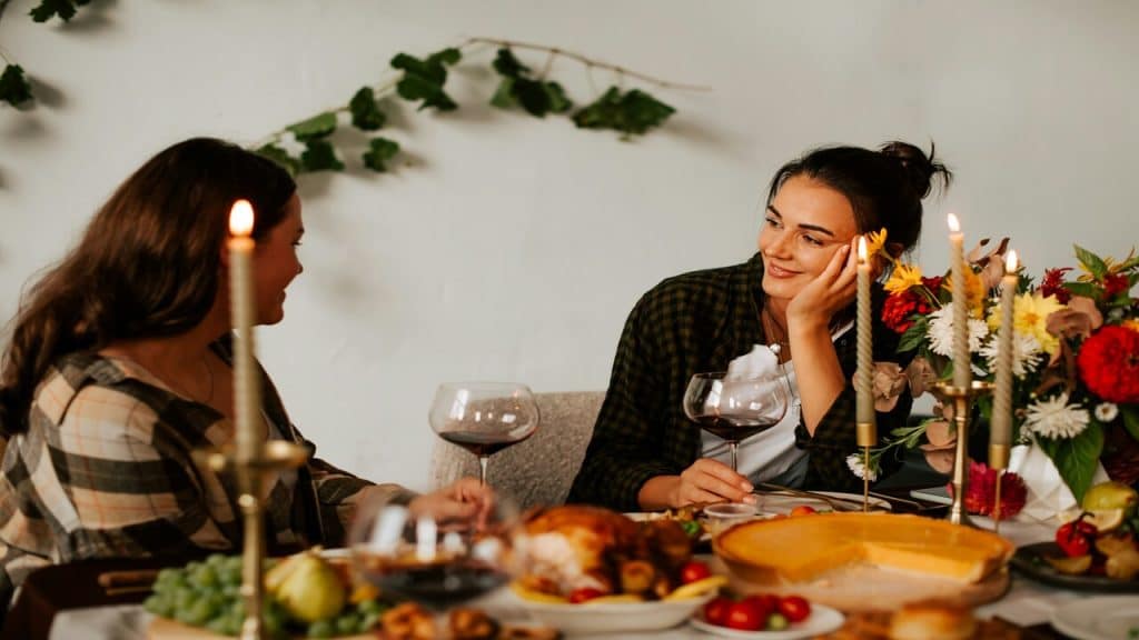 Two women talking over dinner.