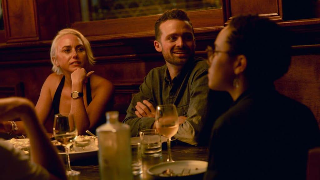 A group of people talking around a restaurant table.