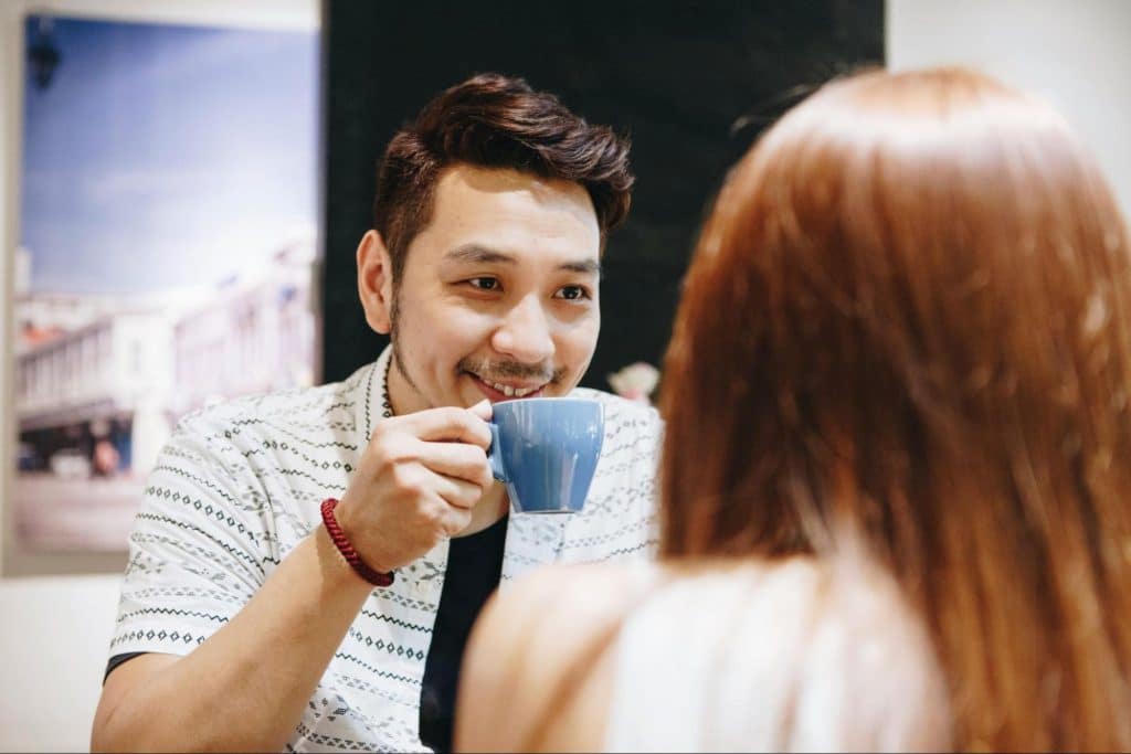A man smiling at the woman