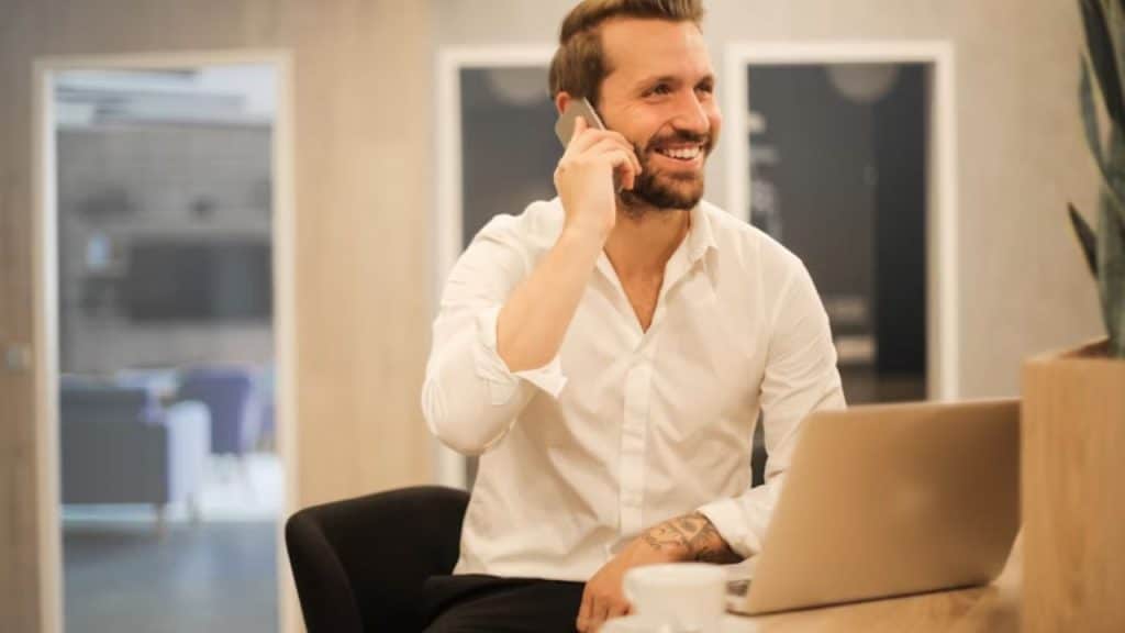 Man smiling while on a phone call or date