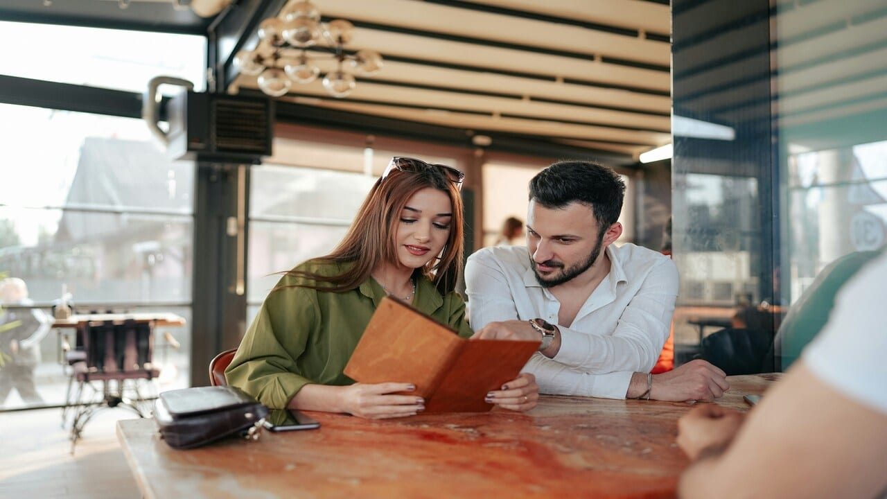 A couple looking at a menu.