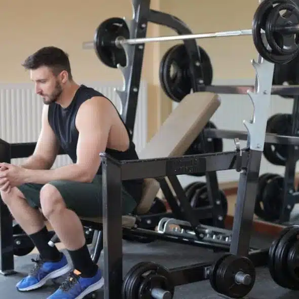 Man in the gym thinking on how to be consistent in wellness routines