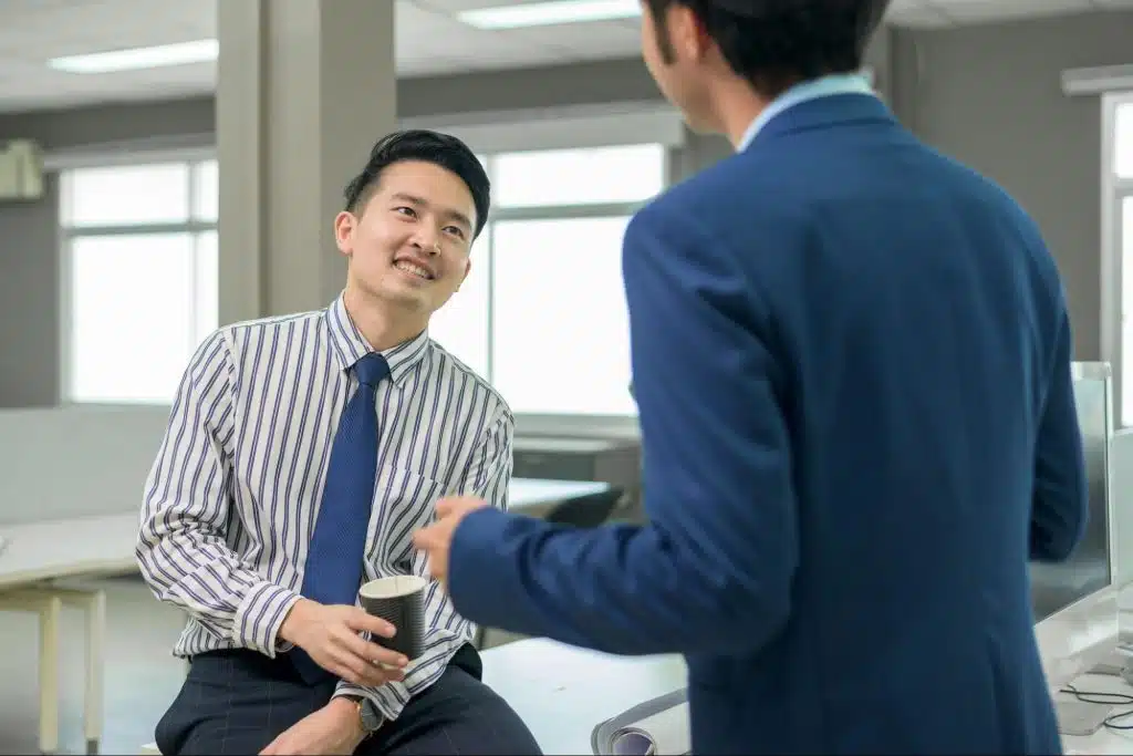 A man talking with his colleague.
