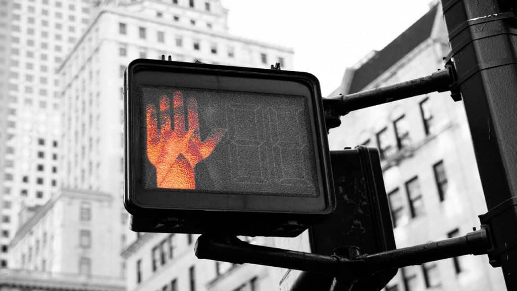 A traffic light flashing “red”