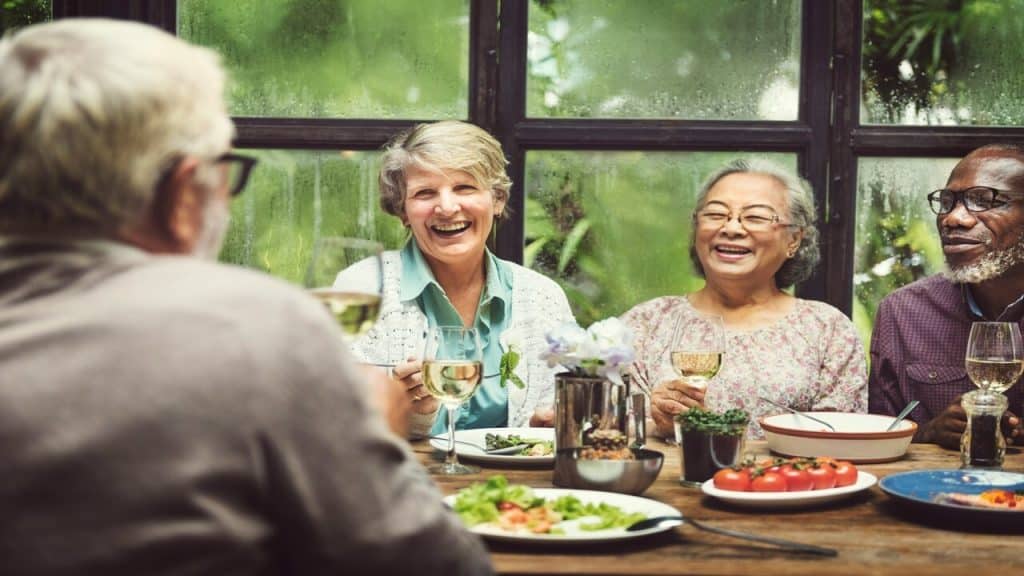 Elderly friends having lunch together