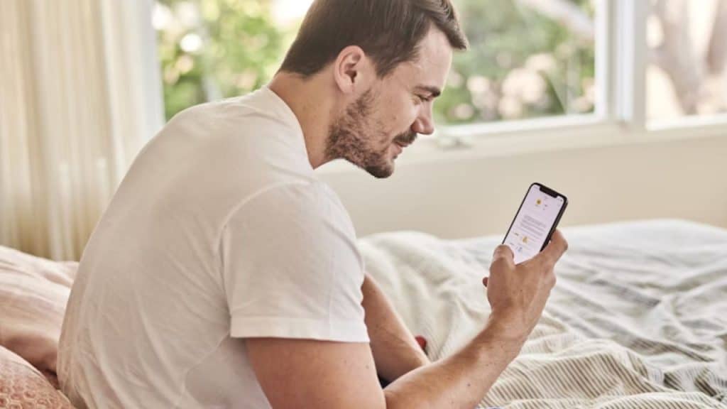 Man texting a thoughtful question with a relaxed demeanor.