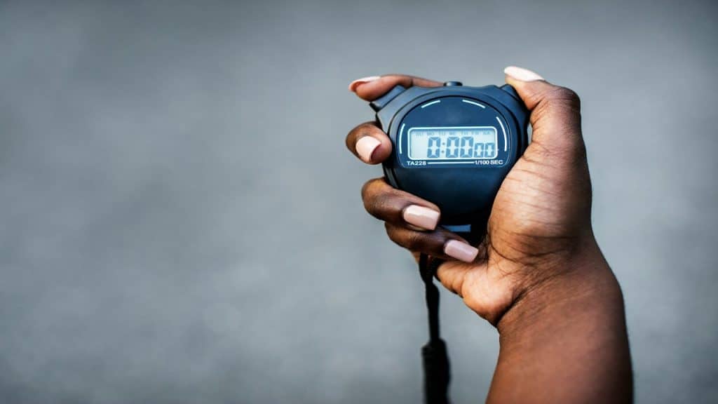 A hand holding a stopwatch
