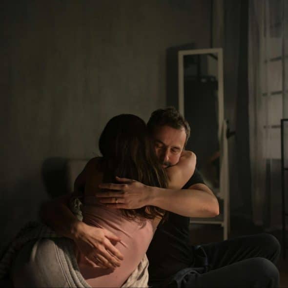 A man hugging a woman
