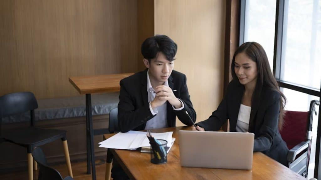 Man and woman looking at future savings plans together.