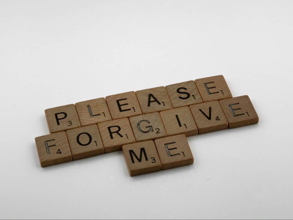 A scrabble letter saying “please forgive me” 