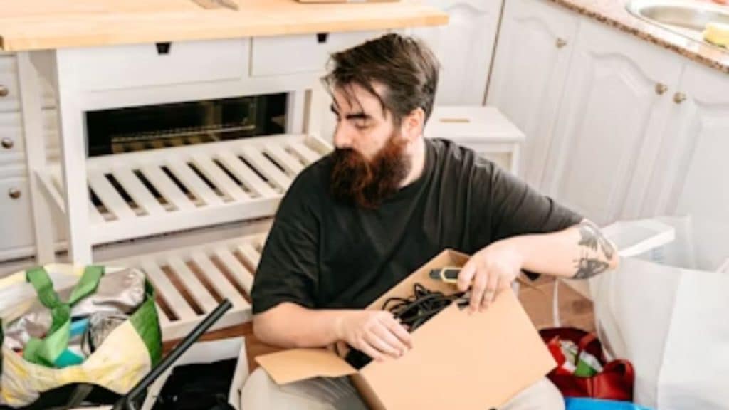 Man sorting through a drawer filled with mysterious tech cables