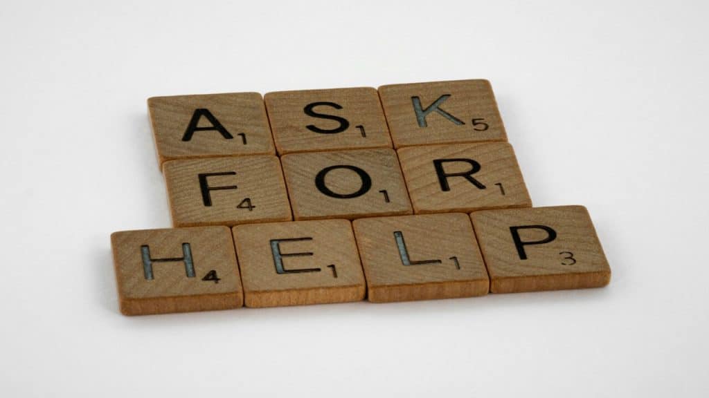 Wooden blocks spelling out “ask for help”.