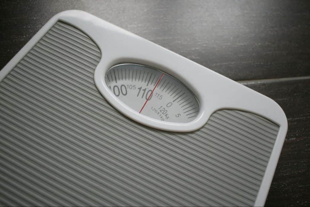 A picture of a person checking his weight
