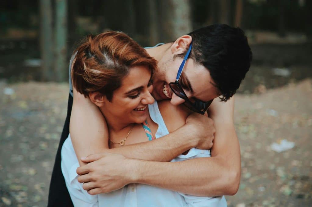 A man hugging a woman