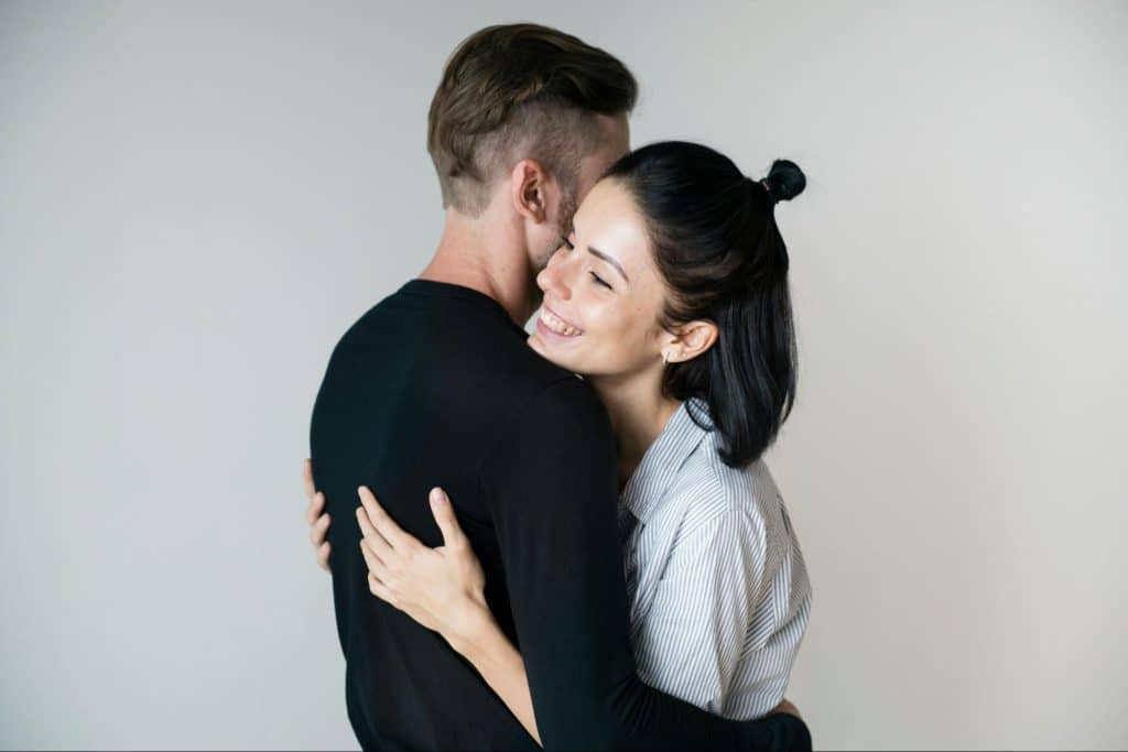 A man and woman hugging each other