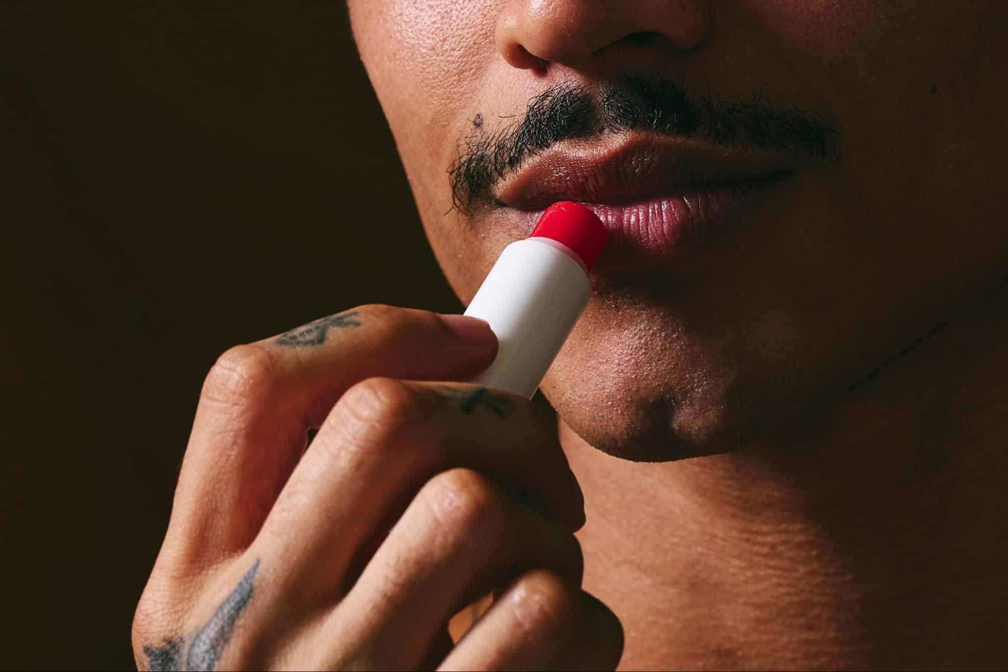 A man using a lip balm.