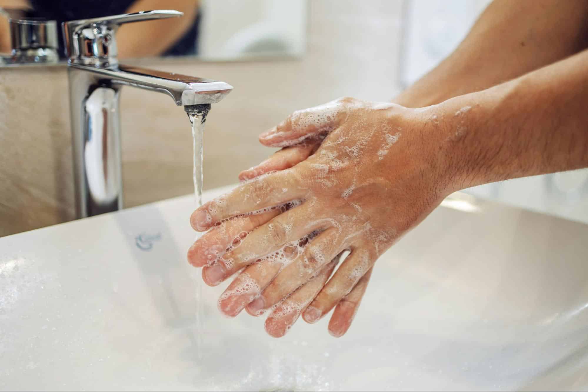 A man washing his hand.