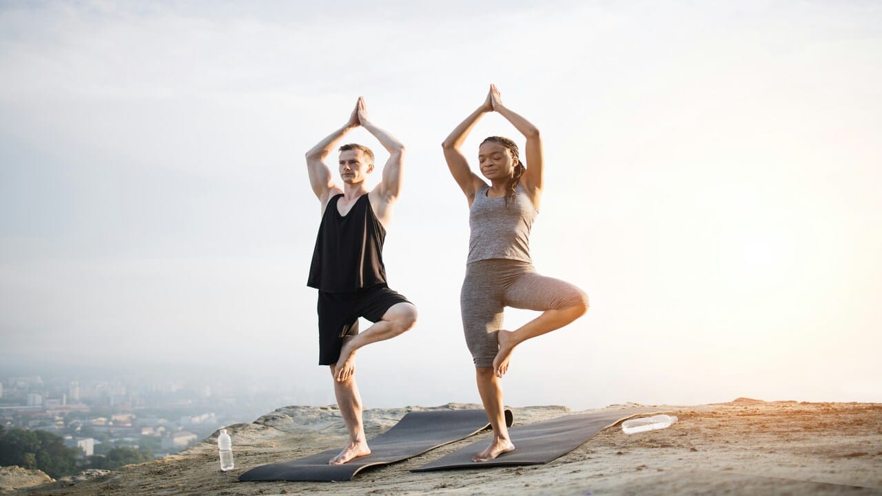 A couple doing yoga together.