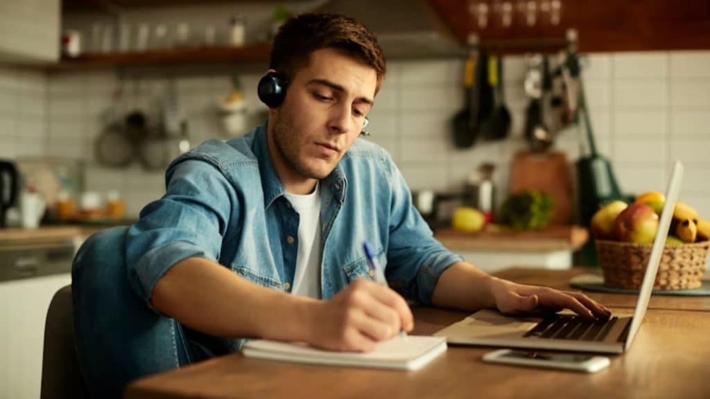 Peaceful man focused on journaling as a personal growth in a quiet setting