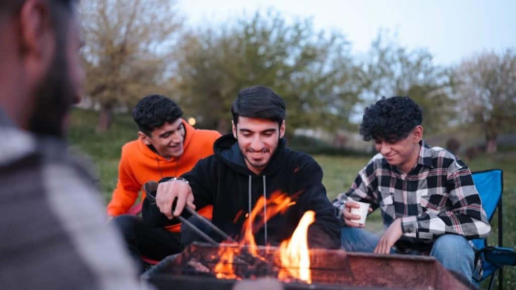 Men cooking together in a home kitchen or backyard grill