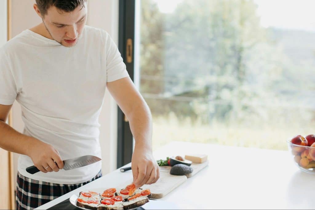 A man preparing what he cooked.