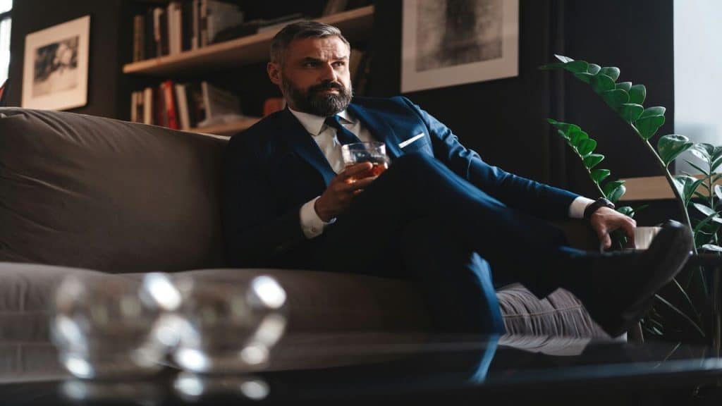 A stylish businessman having whiskey