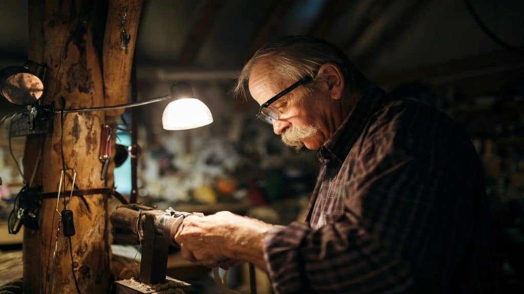 An older man doing carpentry