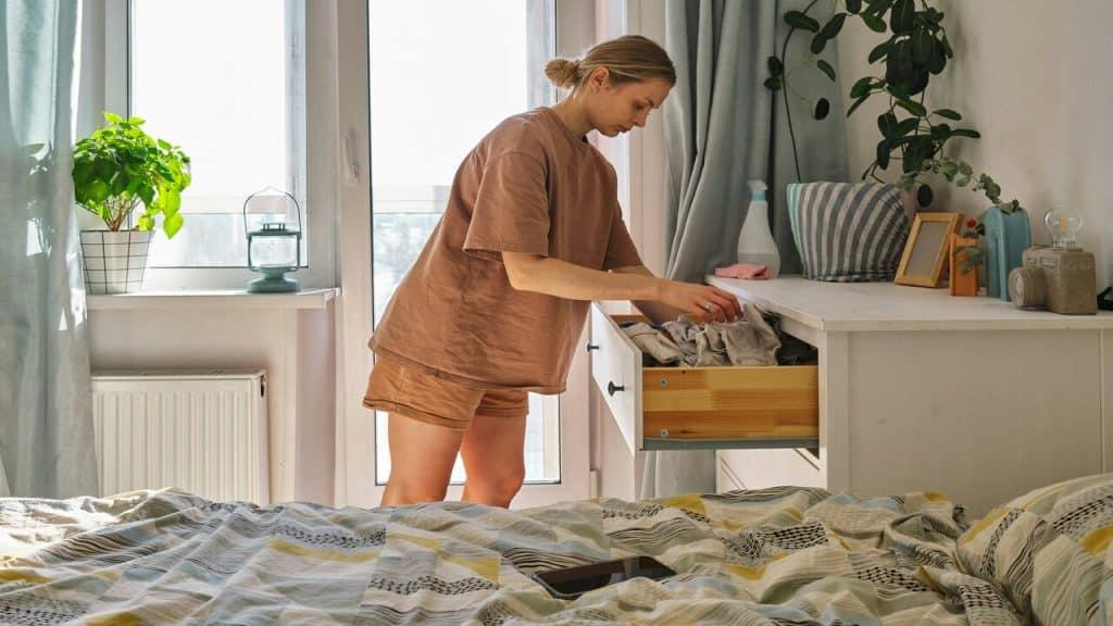 A person cleaning her bedroom