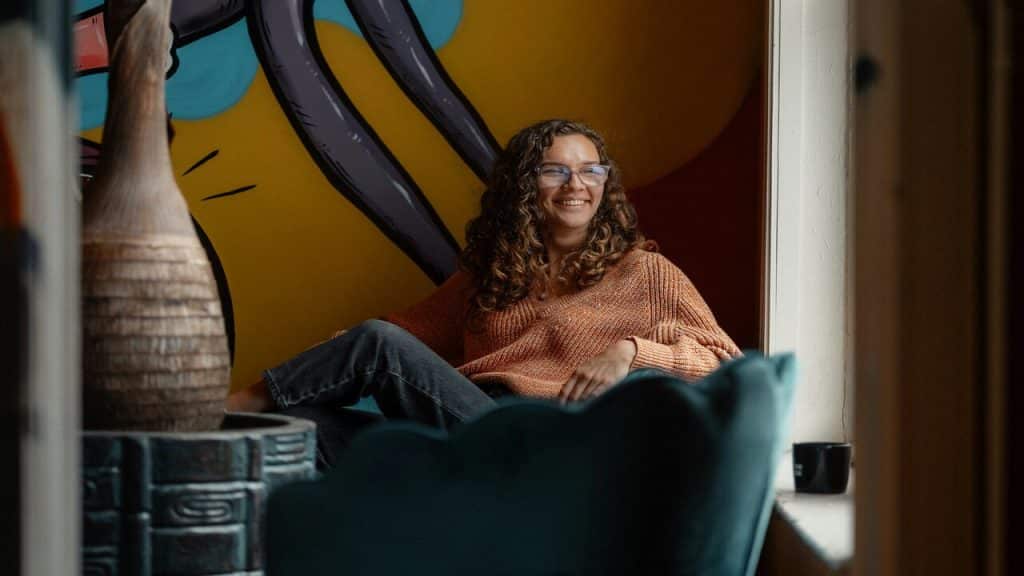An employee smiling alone at work
