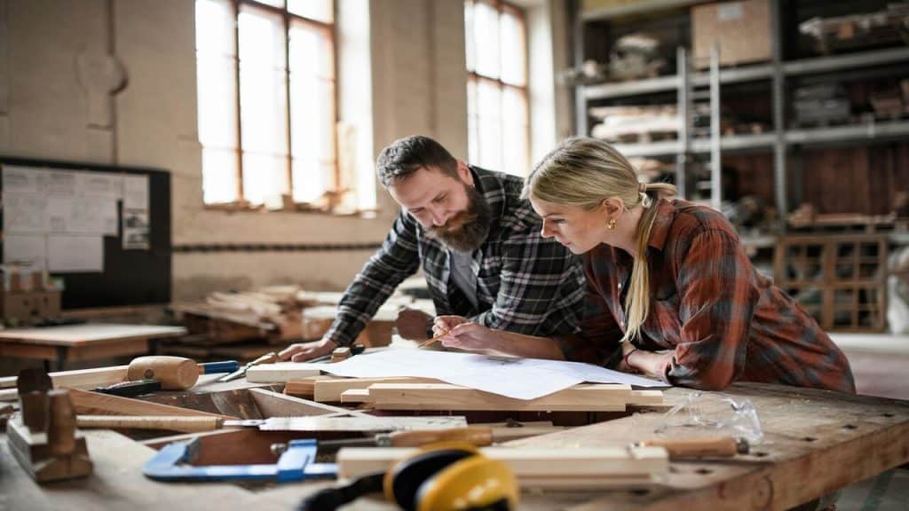 Two people working on a furniture