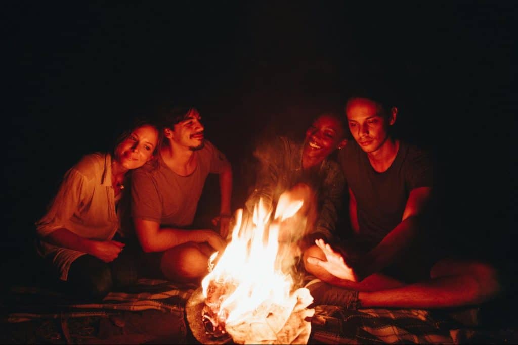 Two couples having a bonfire.