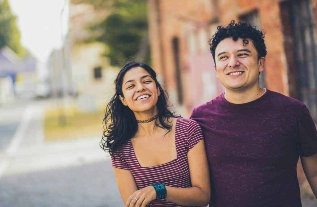 A man and woman walking outside.