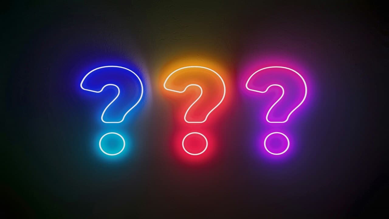 Neon lights shaped into question marks.