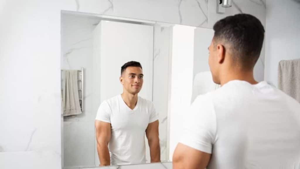 Man looking into mirror  reflecting on self growth and personal evolution