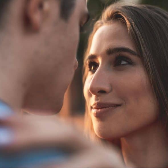 A woman looking at the man.