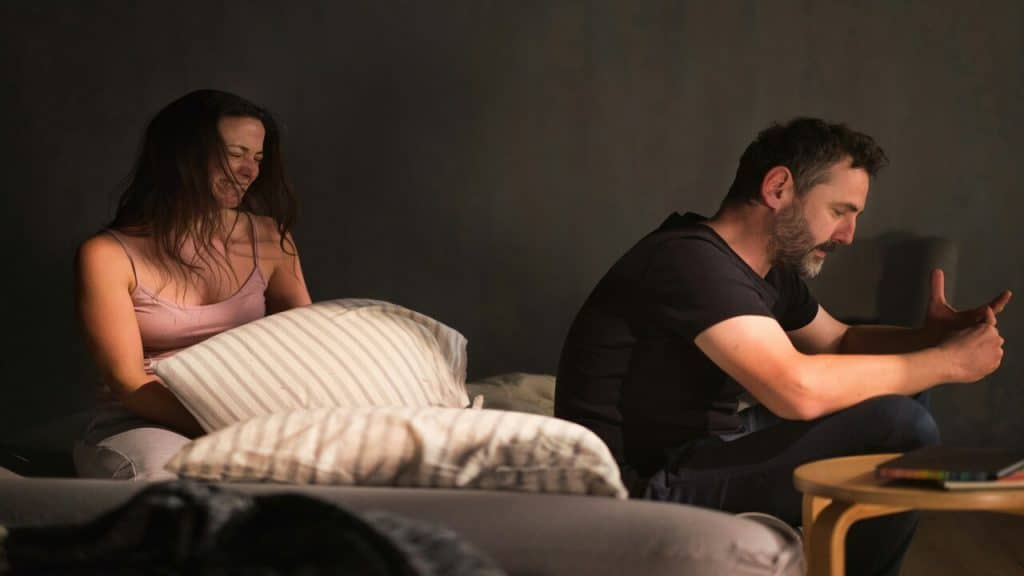 A couple crying in bed