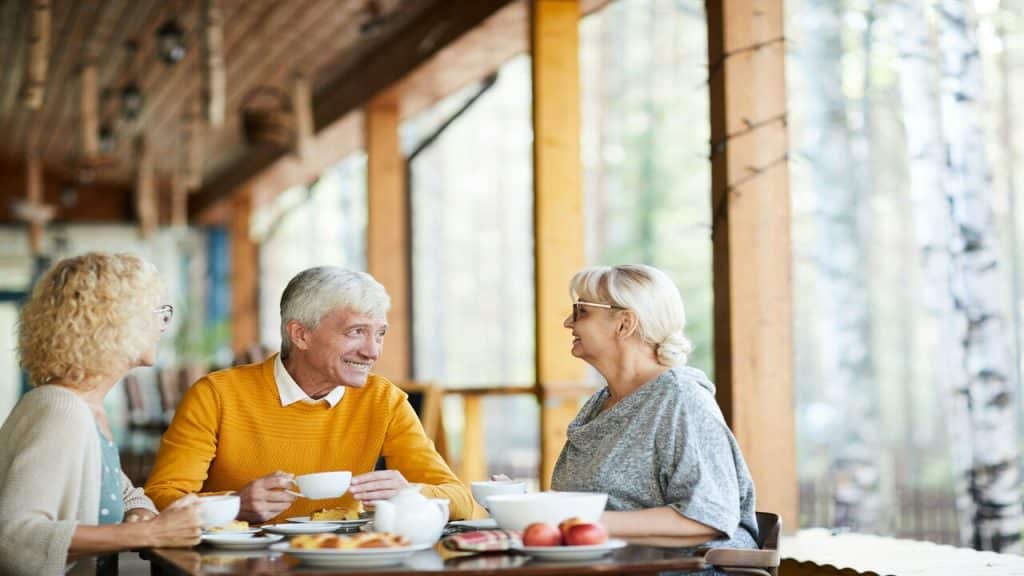 Elderly friends having breakfast together