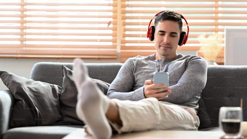 A man relaxing solo with headphones, decompressing from the day