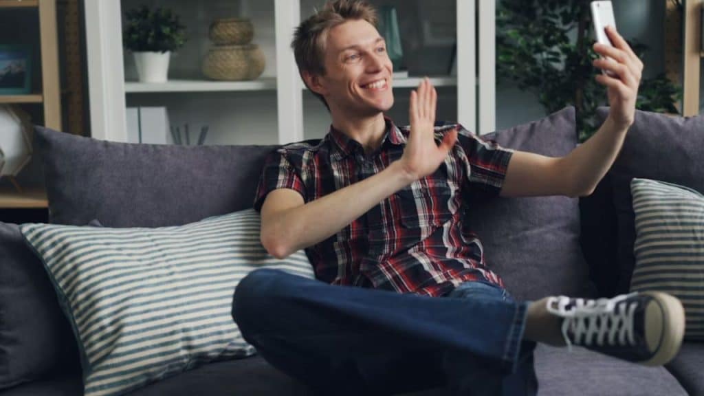 Man surprising partner with a video message.
