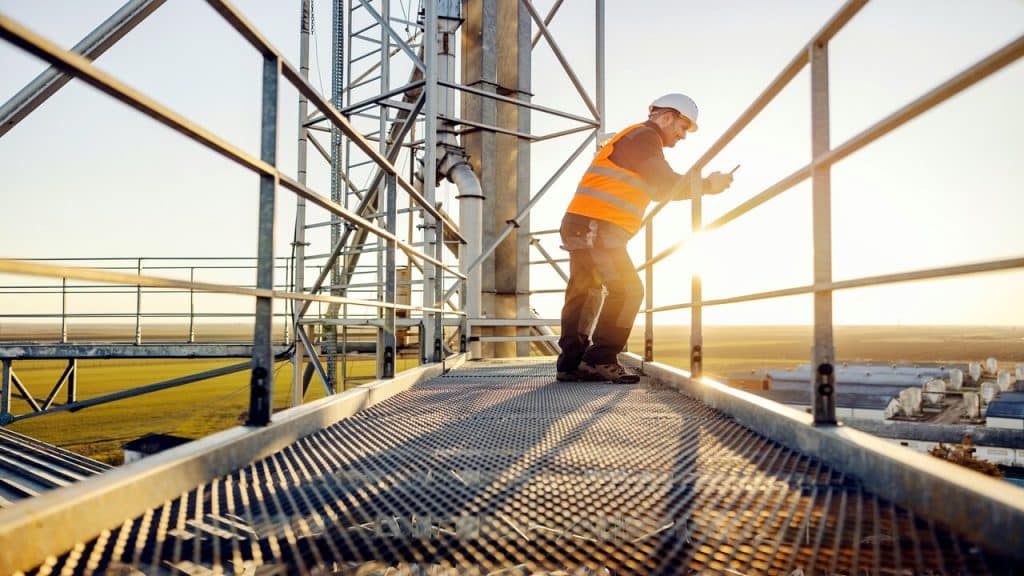 An industry worker on a railing