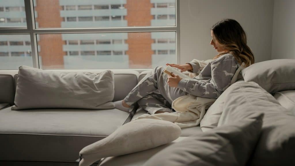 A person reading at home alone