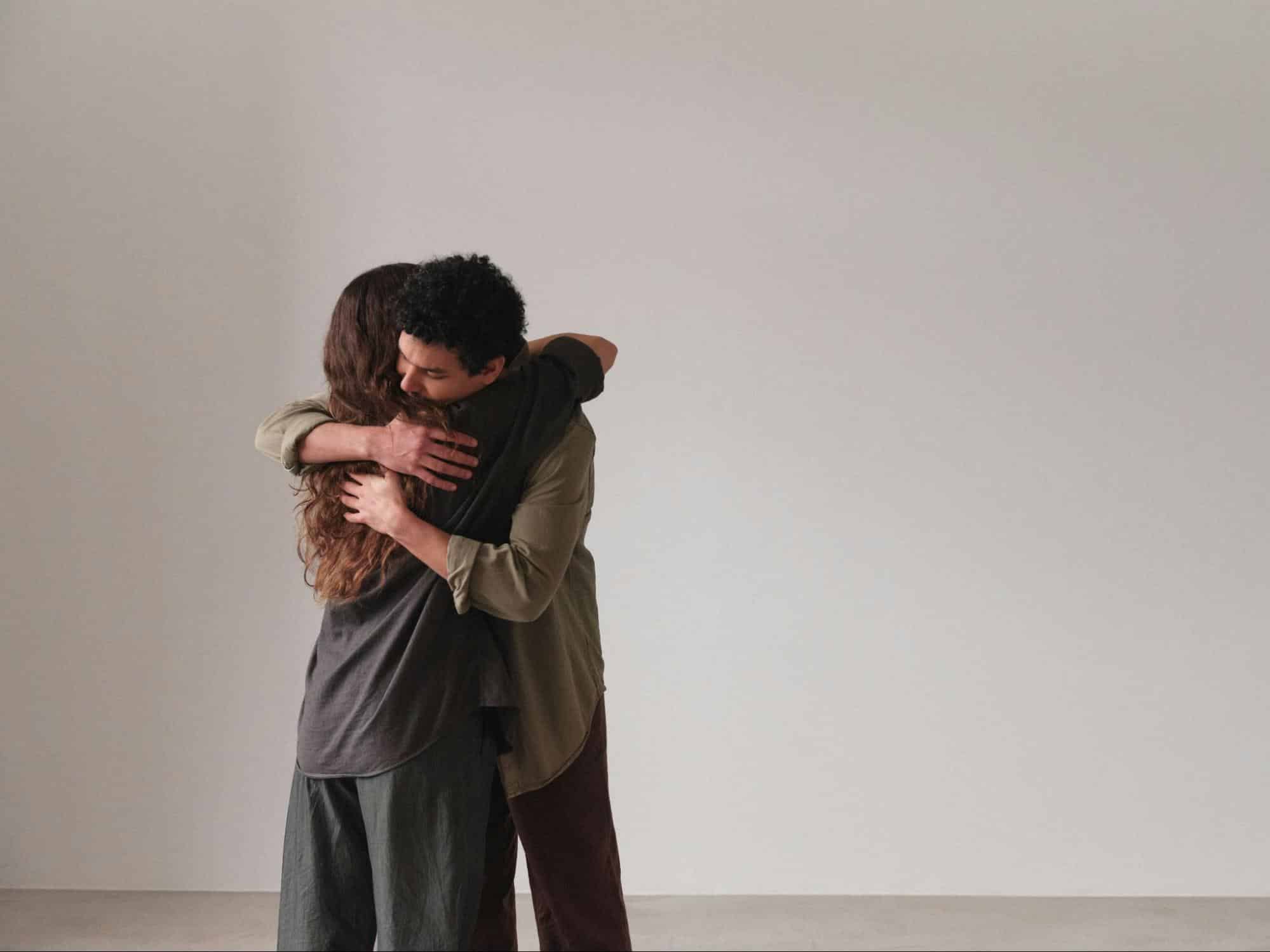 A man hugging a woman.