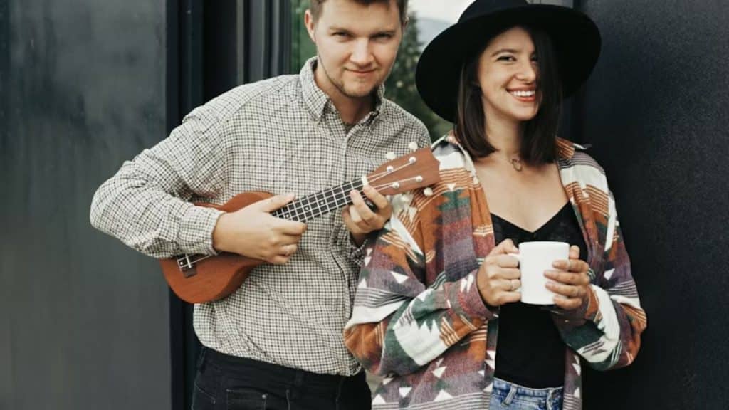 Man surprising woman with a cup of coffee and a song.